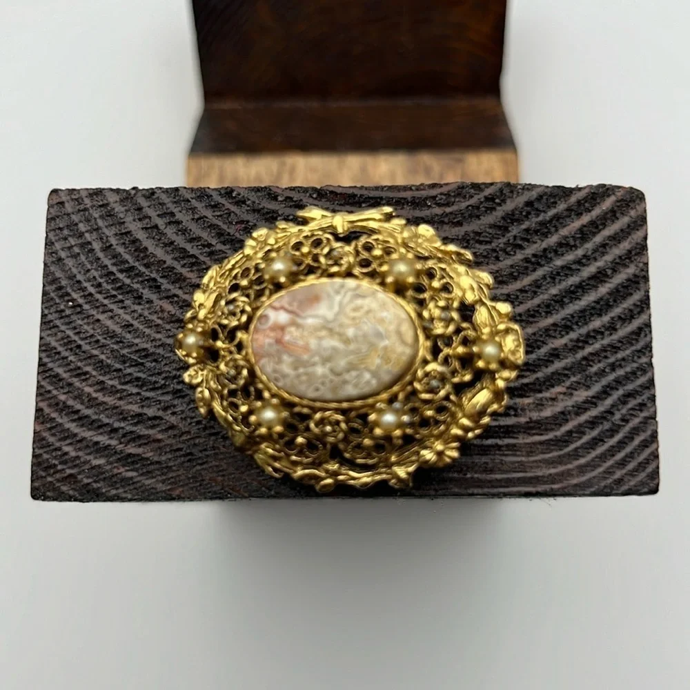 Vintage gold tone earth tone swirl center delicate filigree domed brooch pearls